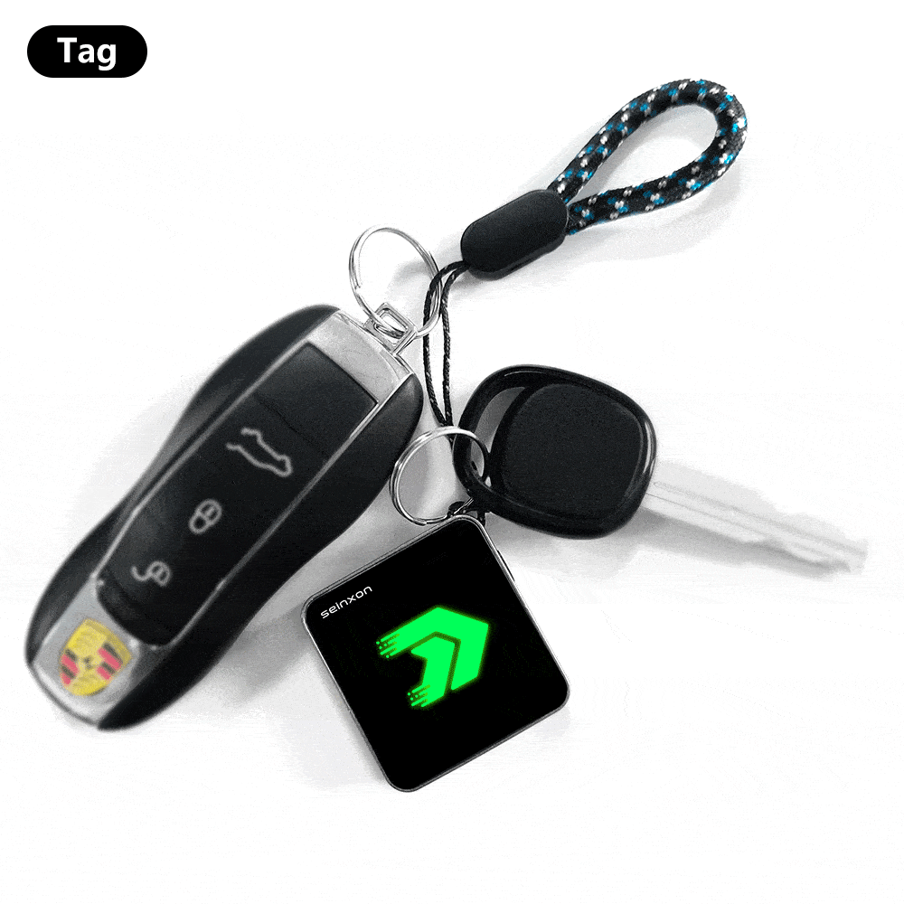 Car-keys-with-an-electronic-Seinxon-key-finder-displaying-a-luminous-green-arrow-icon_-connected-by-a-keyring-with-a-blue-and-black-patterned-lanyard