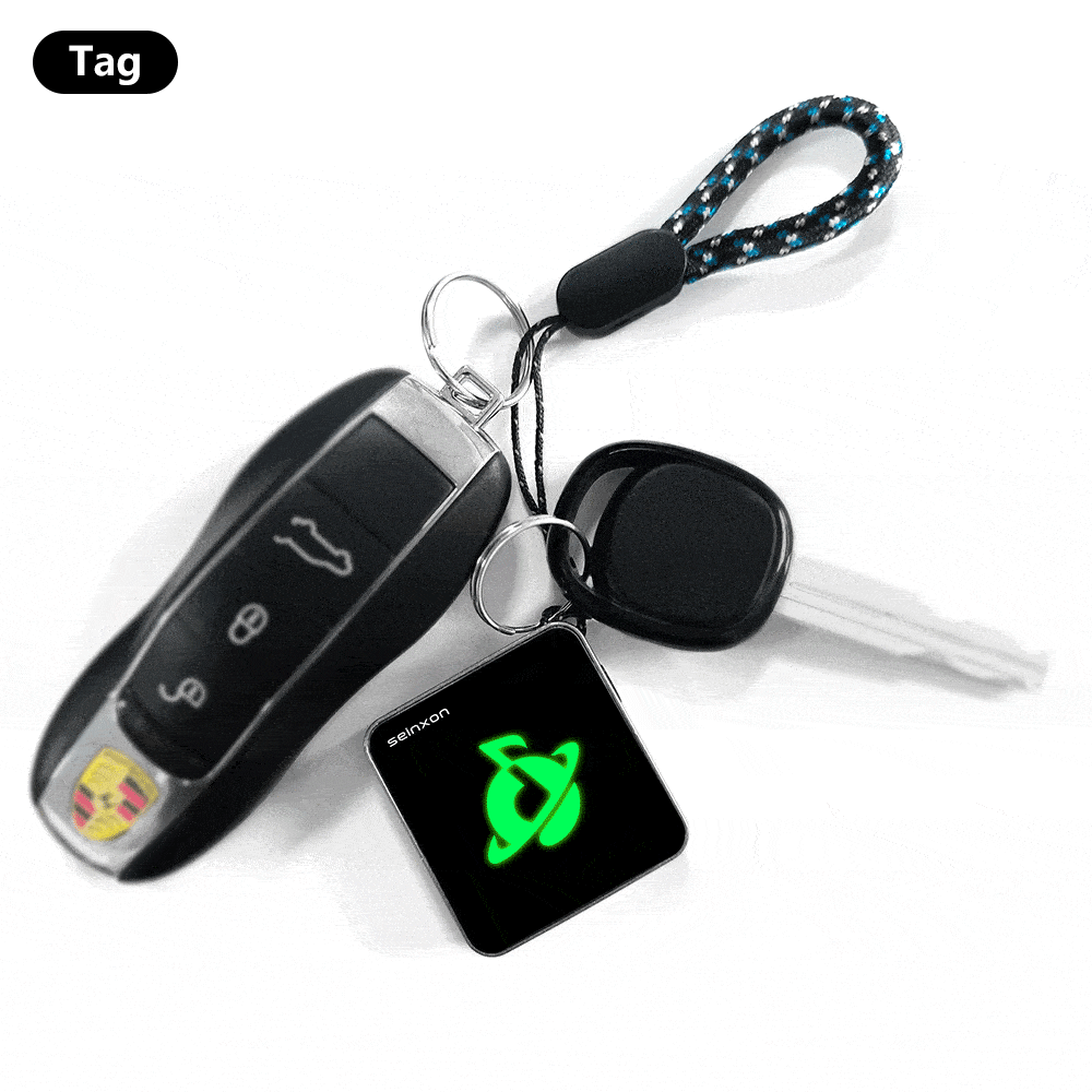 A-set-of-keys-with-a-car-key-fob-and-a-Seinxon-tracker-featuring-a-glowing-green-logo_-attached-to-a-keyring-with-a-decorative-lanyard