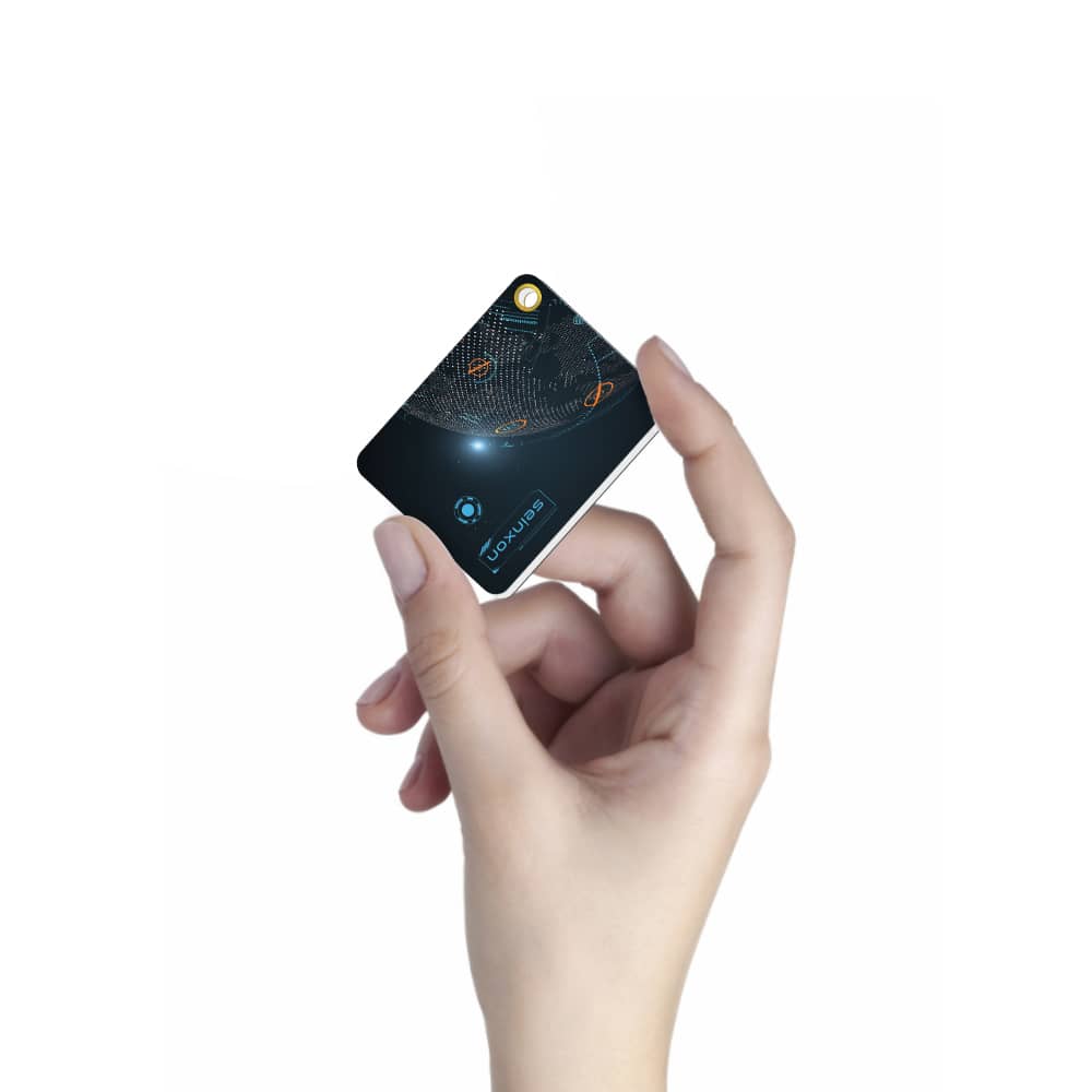 Hand-holding-Seinxon-tracker-card-demonstrating-its-portable-and-lightweight-design-ideal-for-on-the-go-use-and-tracking-with-Find-My-technology