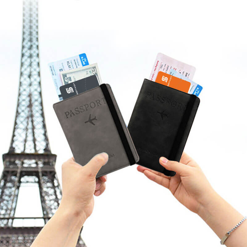 Two-hands-holding-passport-holders-with-card-tracker-for-wallet