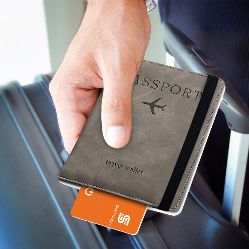 A-man's-hand-holds-a-black-passport-holder-with-a-tracking-device-for-objects