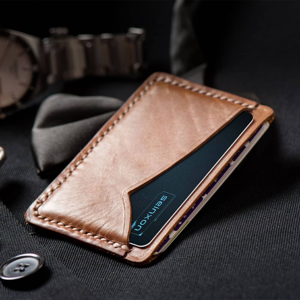 Ultra-thin-Seinxon-tracker-card-nestled-in-a-leather-wallet-showcasing-its-slim-profile-ideal-for-everyday-carry-alongside-bank-cards